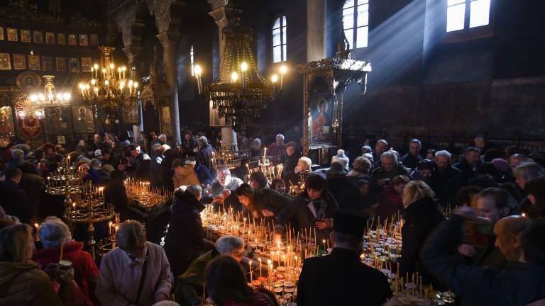 Believers attend a ceremony marking the day of Saint Haralampi, protector of beekeepers, around a cross-shaped platform covered with candles placed in jars of honey, at the Church of the Blessed Virgin in Blagoevgrad, on February 10, 2020. (Photo by NIKOLAY DOYCHINOV / AFP)